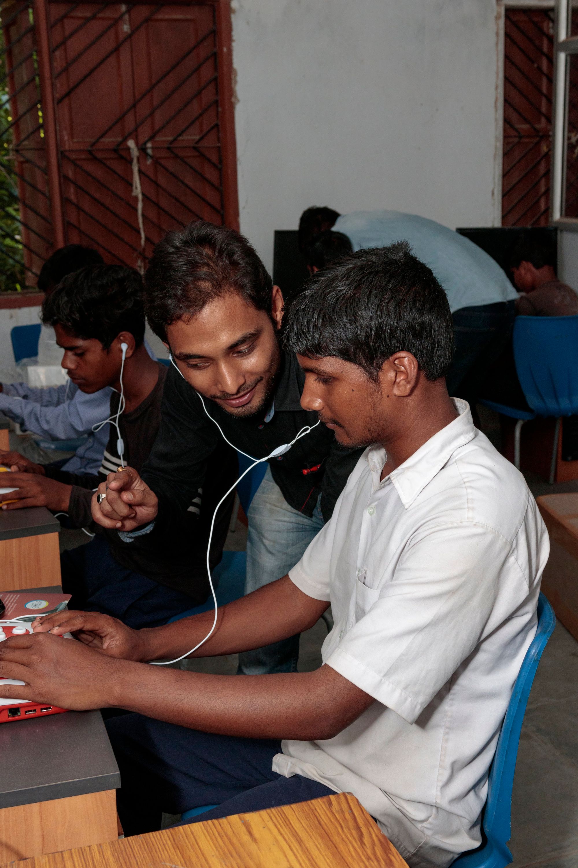 A teacher assists a visually impaired student