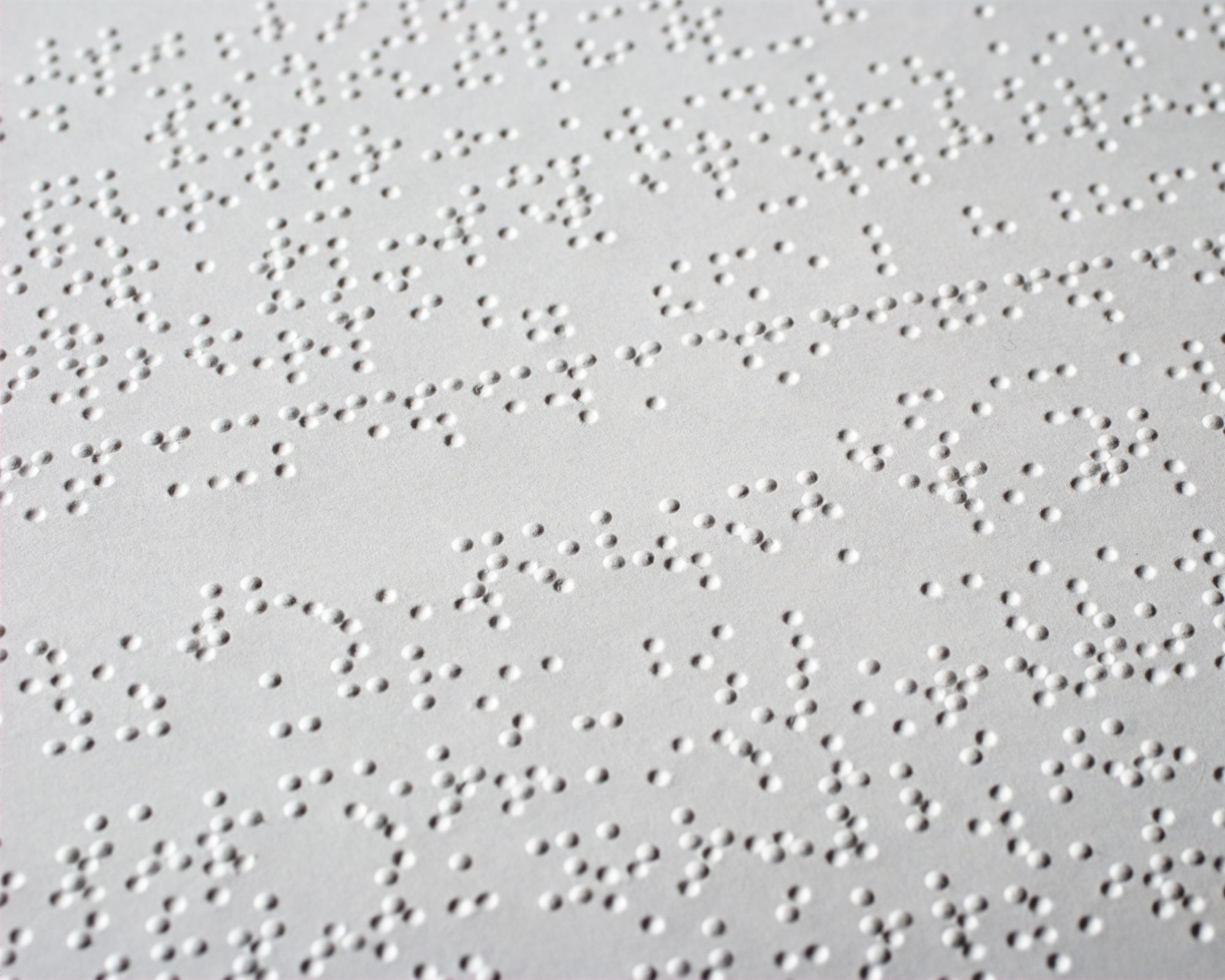 Braille text appears on white paper