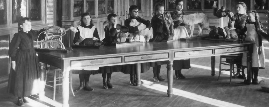 Students at Perkins School for the Blind, 1829. The children are at a long table with various taxidermied animals on it