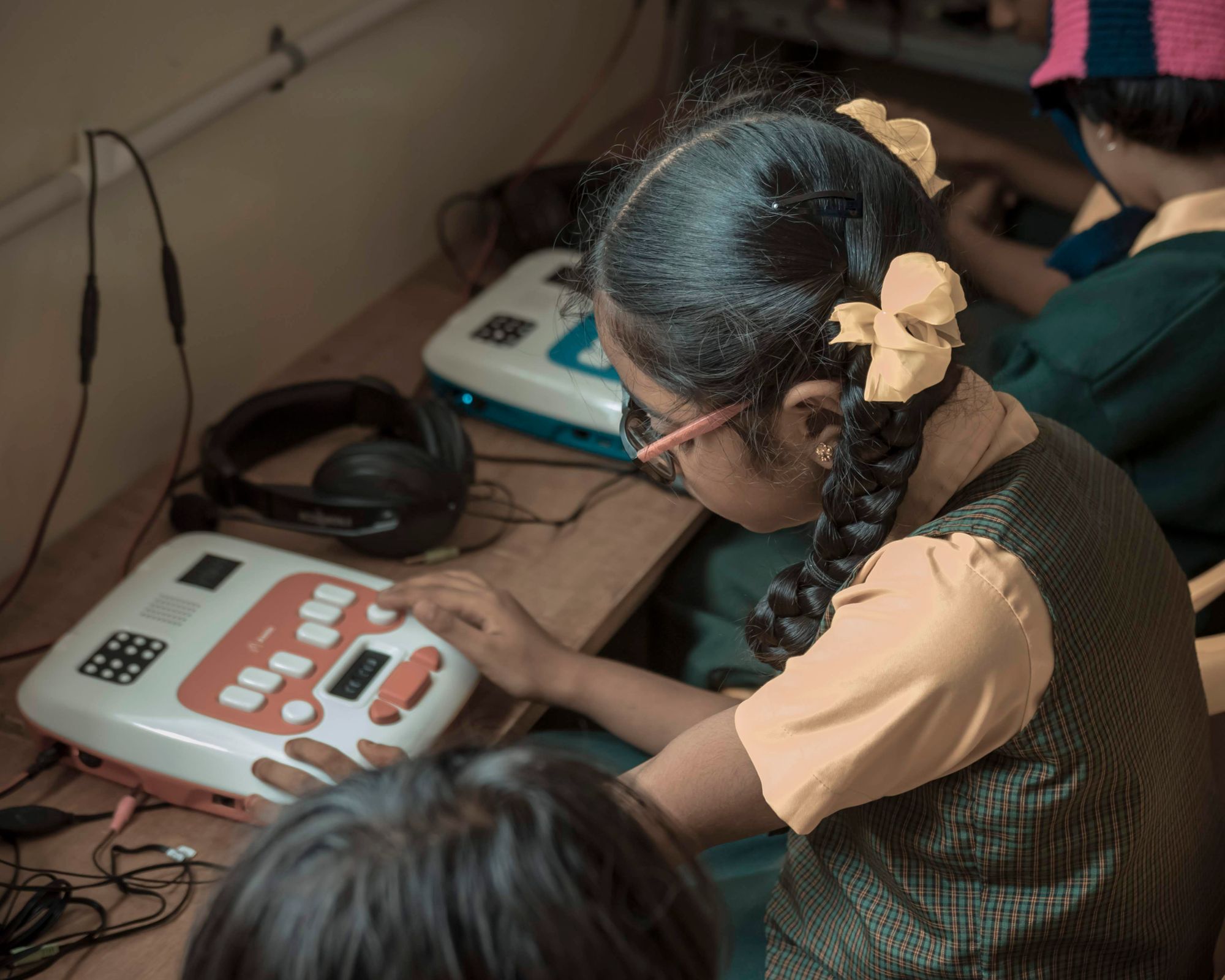 A girl in green and yellow uniform is using her Annie