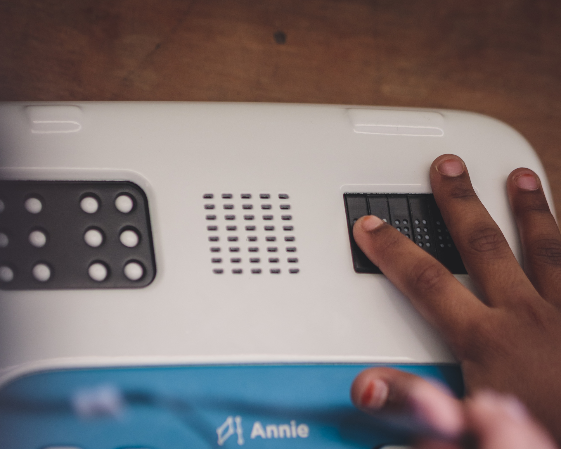 Close up of child reading Braille from Annie's six standard cells